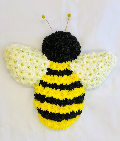 <h2>Bespoke Black and Yellow Bee Tribute | Funeral Flowers</h2>
<ul>
<li>Approximate Size W 50cm H 50cm</li>
<li>Hand created black and yellow bumblebee</li>
<li>To give you the best we may occasionally need to make substitutes</li>
<li>Funeral Flowers will be delivered at least 2 hours before the funeral</li>
<li>For delivery area coverage see below</li>
</ul>
<br>
<h2>Liverpool Flower Delivery</h2>
<p>We have a wide selection of Bespoke Funeral Tributes offered for Liverpool Flower Delivery. Bespoke Funeral Tributes can be provided for you in Liverpool, Merseyside and we can organize Funeral flower deliveries for you nationwide. Funeral Flowers can be delivered to the Funeral directors or a house address. They can not be delivered to the crematorium or the church.</p>
<br>
<h2>Flower Delivery Coverage</h2>
<p>Our shop delivers funeral flowers to the following Liverpool postcodes L1 L2 L3 L4 L5 L6 L7 L8 L11 L12 L13 L14 L15 L16 L17 L18 L19 L24 L25 L26 L27 L36 L70 If your order is for an area outside of these we can organise delivery for you through our network of florists. We will ask them to make as close as possible to the image but because of the difference in stock and sundry items it may not be exact.</p>
<br>
<h2>Liverpool Funeral Flowers | Bespoke Tributes</h2>
<p>This bespoke bumblebee has been loving handcrafted by our expert florists and features a mass of black and yellow spray chrysanthemums, together with white wings and antennas. The bee symbolizes community, brightness and personal power or this would be a fitting tribute to a beekeeper.</p>
<br>
<p>Bespoke Funeral Tributes are a way to create a tribute that is truly unique and specially designed for a loved one.</p>
<br>
<p>These are sometimes selected by family members as the main tribute or more often a group of friends or workplace colleagues as a symbol of things they associate with the deceased.</p>
<br>
<p>The flowers are arranged in floral foam, which means the flowers have a water source so they look their very best for the day.</p>
<br>
<p>Containing white, yellow and black double spray chrysanthemums and 2 yellow craspedia for decoration.</p>
<br>
<h2>Best Florist in Liverpool</h2>
<p>Trust Award-winning Liverpool Florist, Booker Flowers and Gifts, to deliver funeral flowers fitting for the occasion delivered in Liverpool, Merseyside and beyond. Our funeral flowers are handcrafted by our team of professional fully qualified who not only lovingly hand make our designs but hand-deliver them, ensuring all our customers are delighted with their flowers. Booker Flowers and Gifts your local Liverpool Flower shop.</p>
<br>
<p><em>Debera G - 5 Star Review on yell.com - Funeral Florist Liverpool</em></p>
<br>
<p><em>Fleur and her team made the flowers for my Dad's funeral. I knew I wanted something quite specific but was quite unsure how to execute the idea. Fleur understood immediately what I was hoping to achieve and developed the ideas into amazingly beautiful flowers that were just perfect. I honestly can't recommend her highly enough - she created something outstanding and unique for my Dad. Thanks Fleur.</em></p>